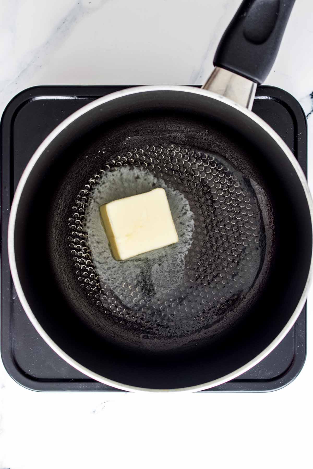 Pat of butter melting in a saucepan