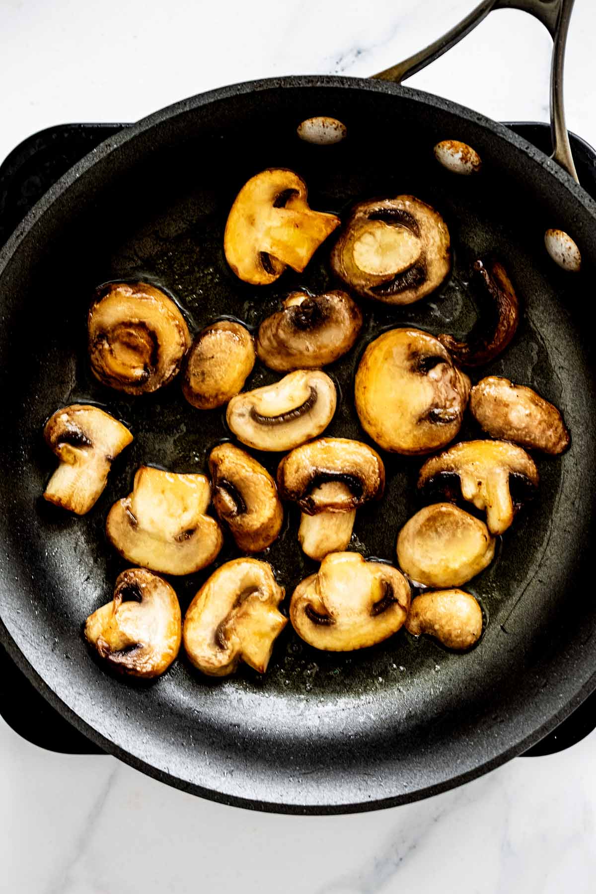 Cooked sliced mushrooms in a skillet