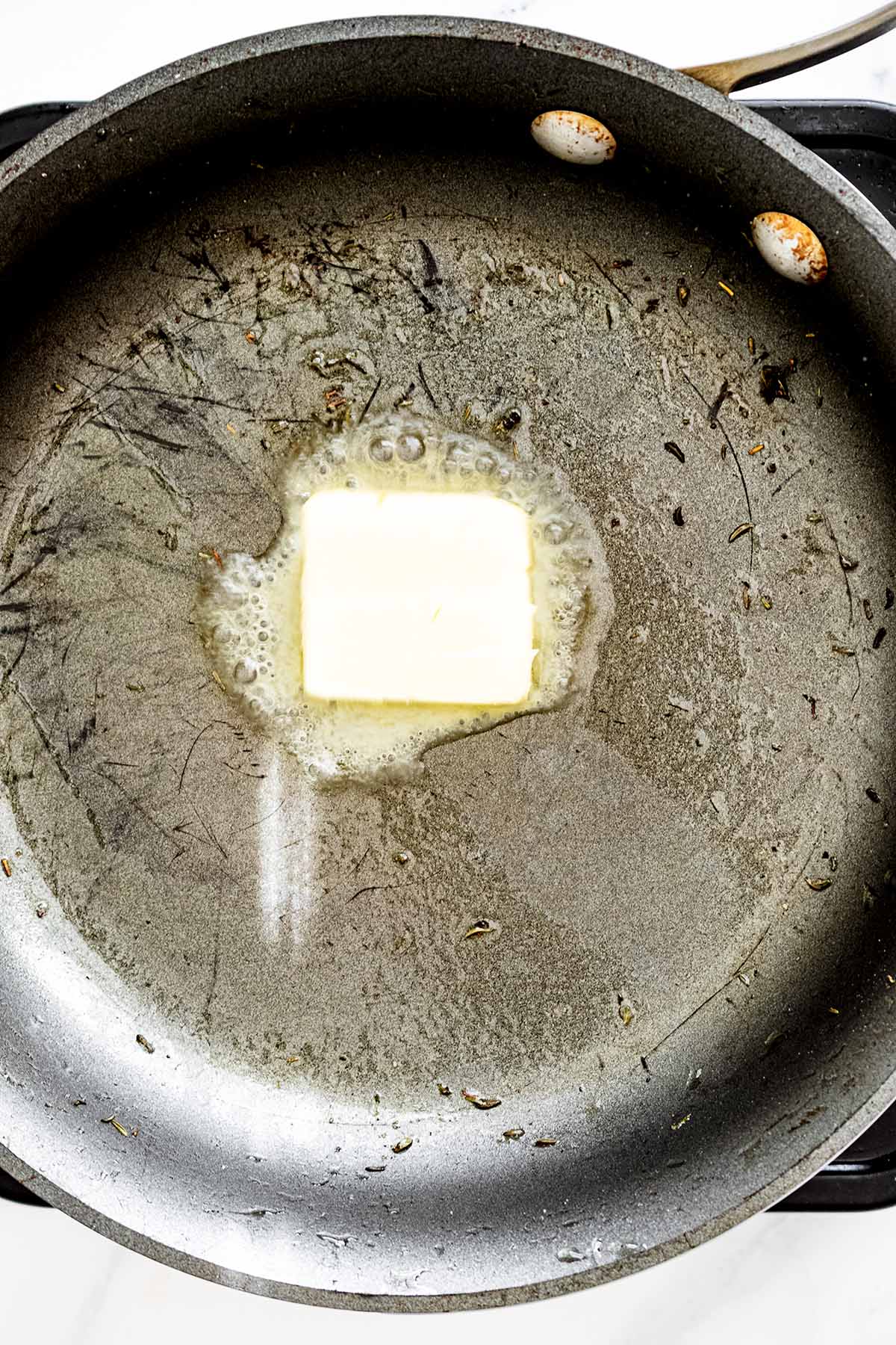 Pat of butter melting in a skillet