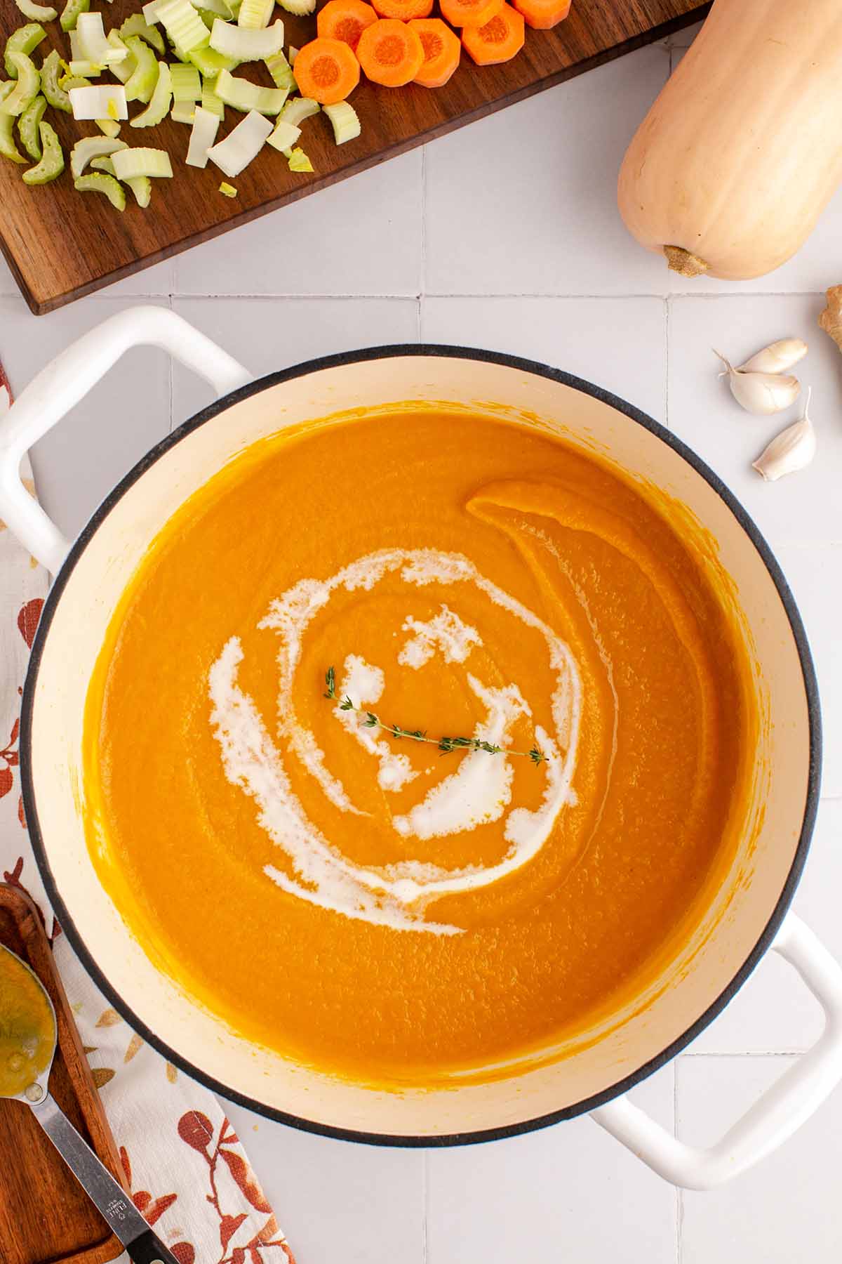 Overhead view of a pot of creamy butternut squash soup.