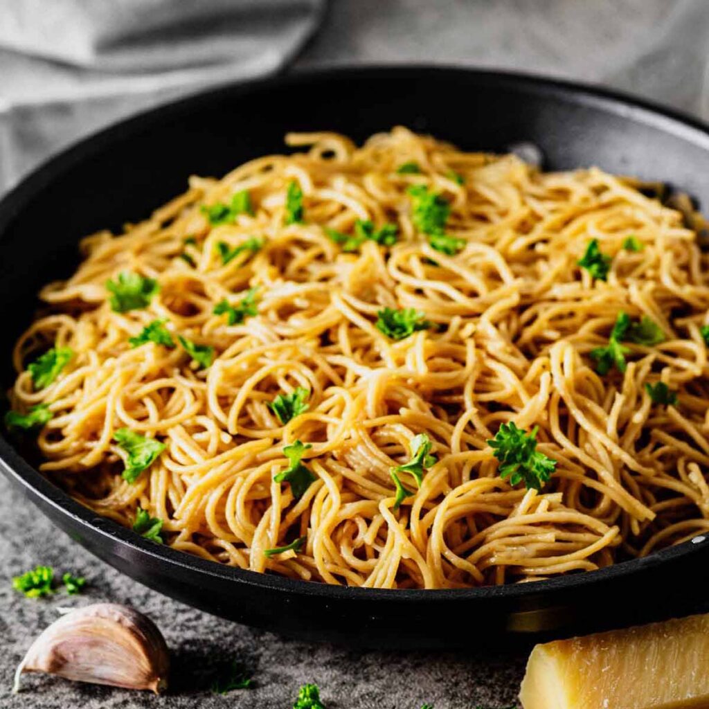 Close up of Parmesan butter noodles in a skillet.