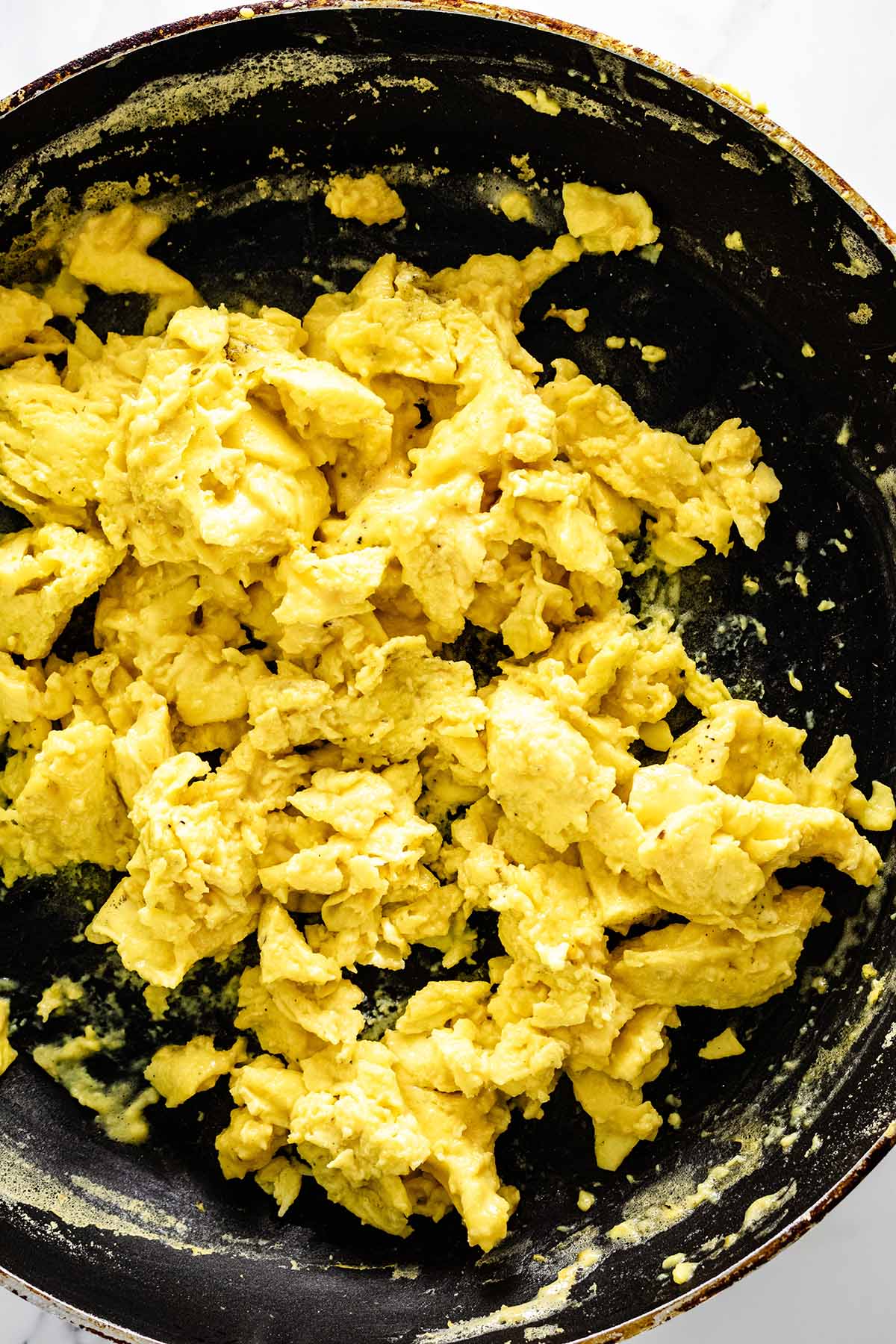 Cooked scrambled eggs in a skillet