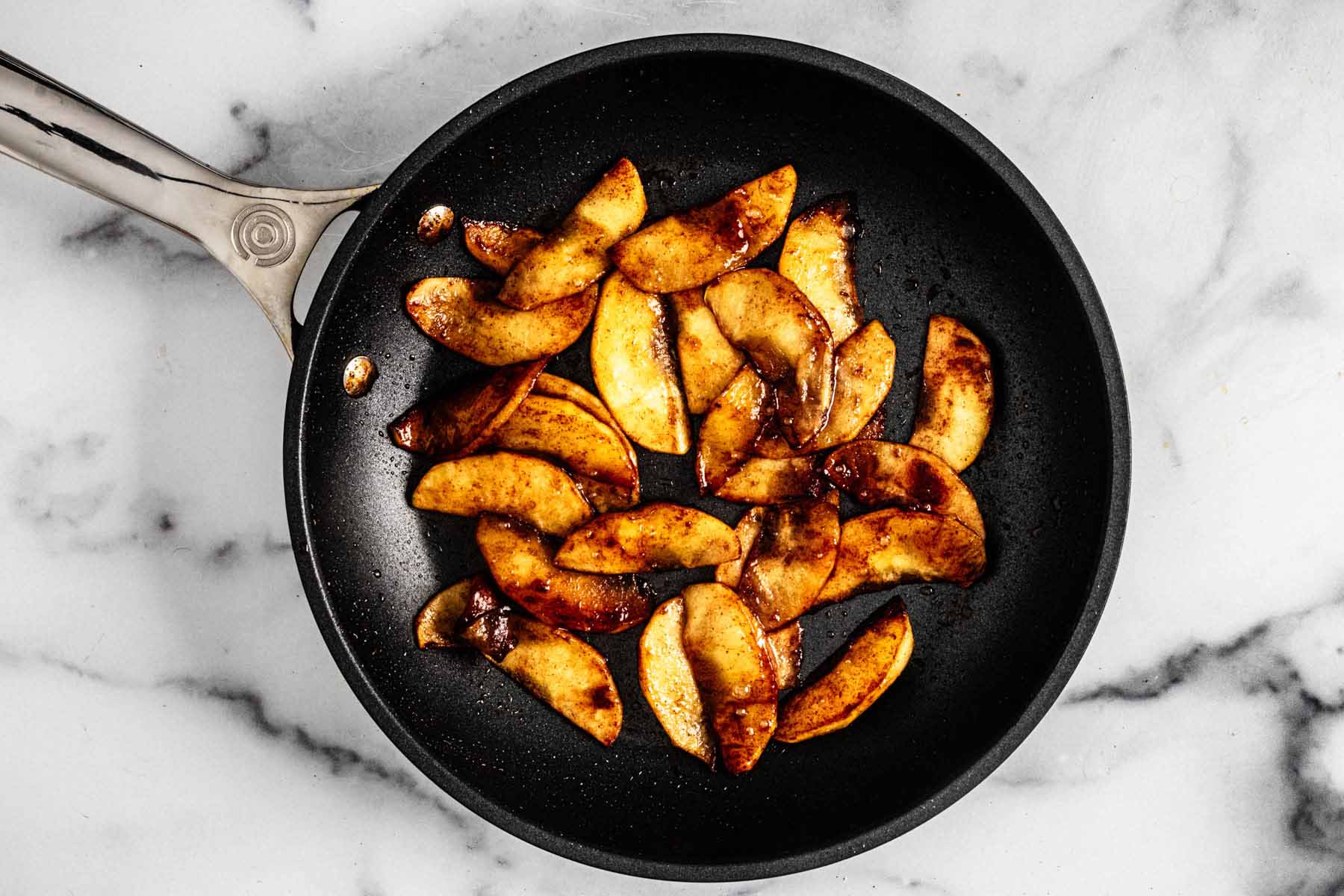 Caramelized apples in a small skillet.