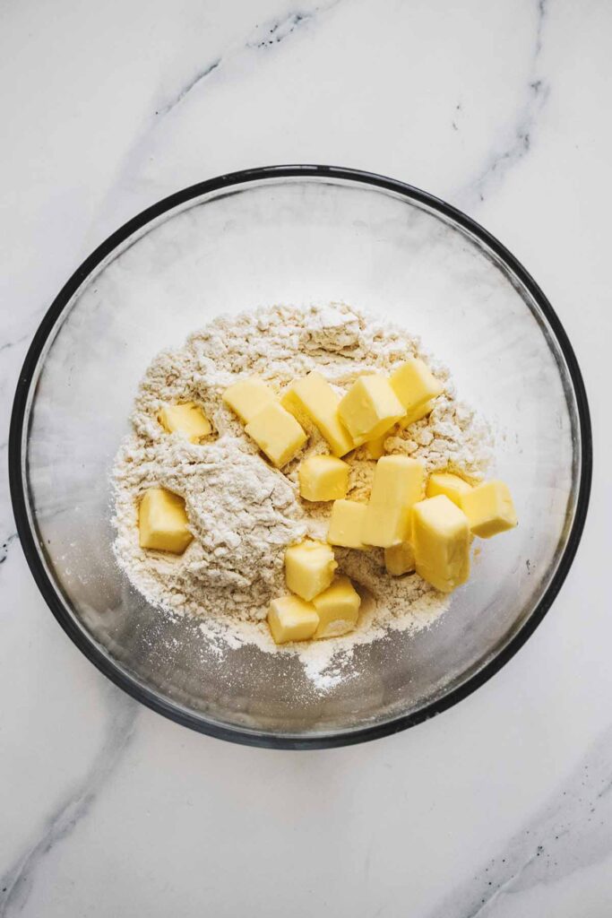 Flour and chopped butter in a glass bowl