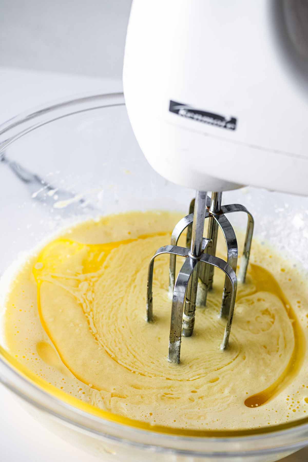 Wet ingredients being mixed with an electric mixer