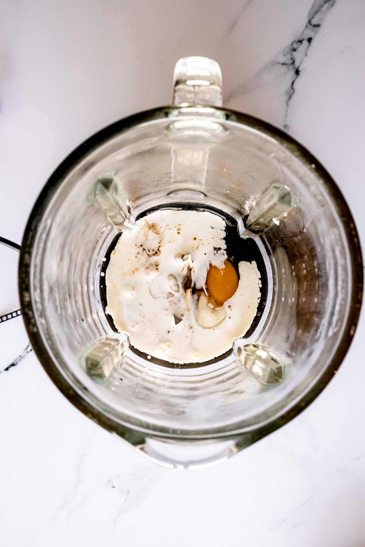Overhead view of egg mixture in a blender
