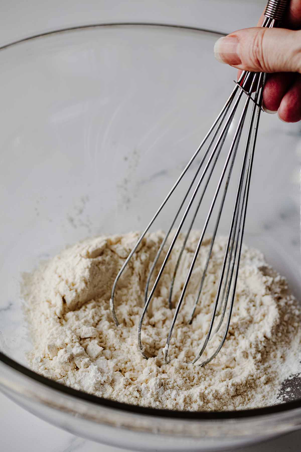 Dry ingredients being whisked with a wire whisk