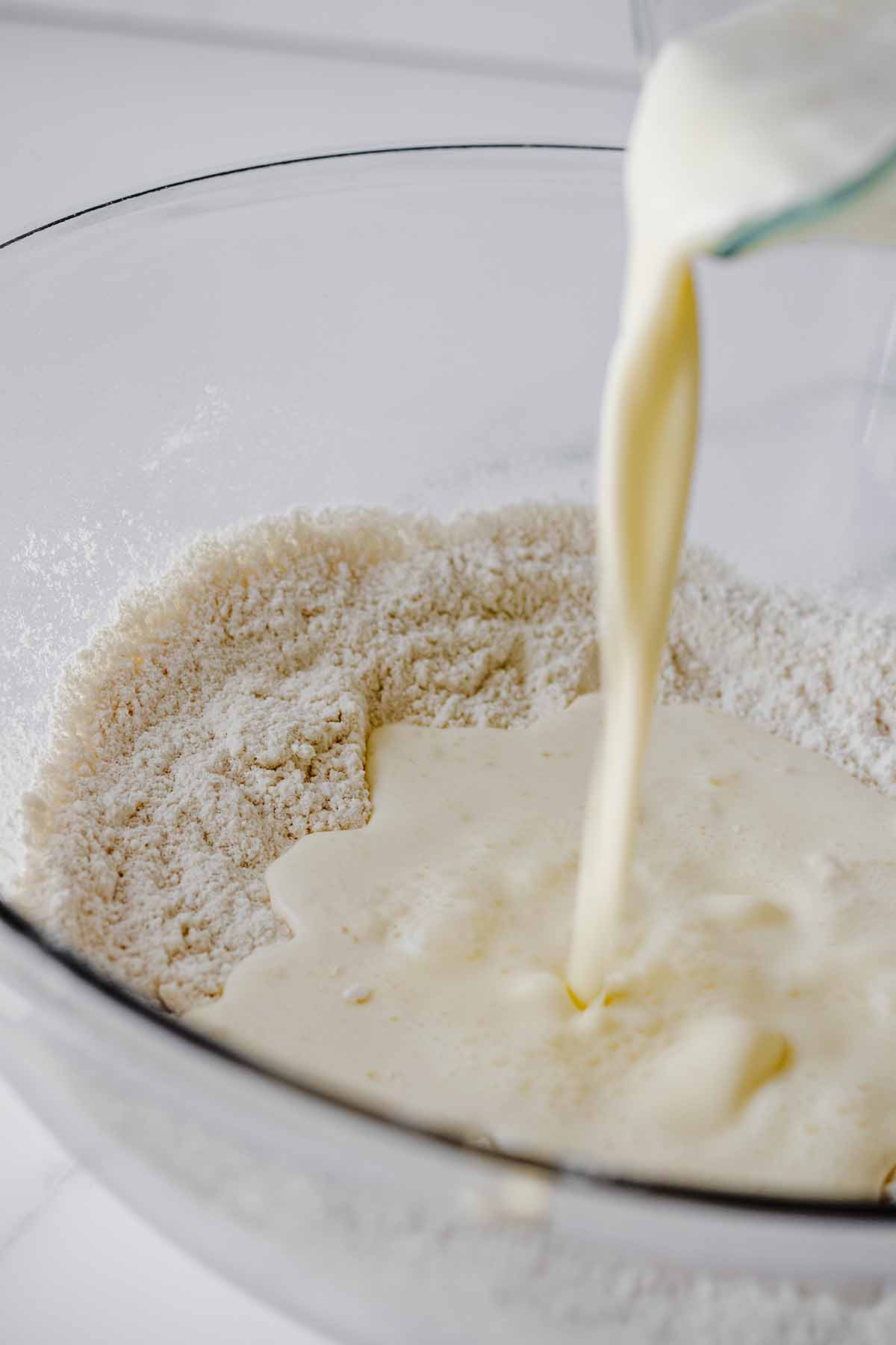 Wet ingredients being poured into dry ingredients