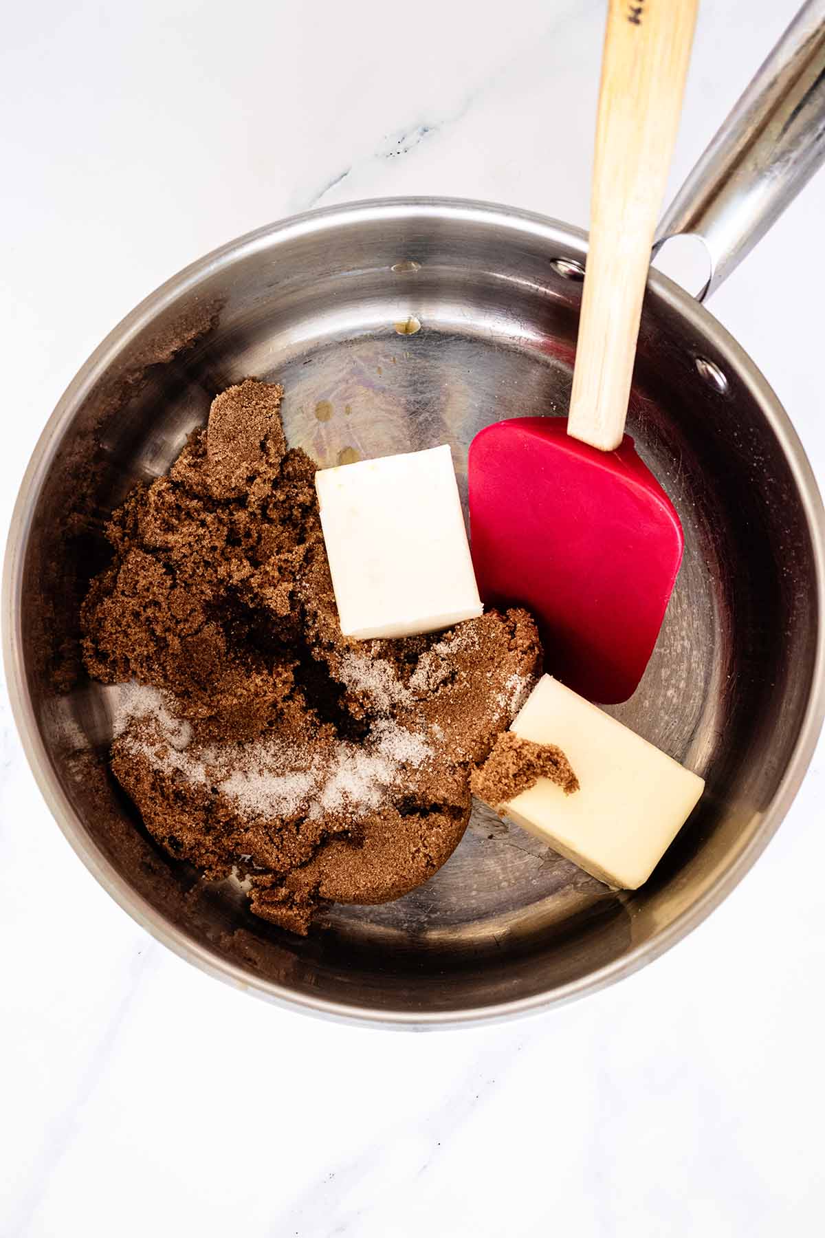 Butter, brown sugar, extract and salt in a saucepan with a red spatula