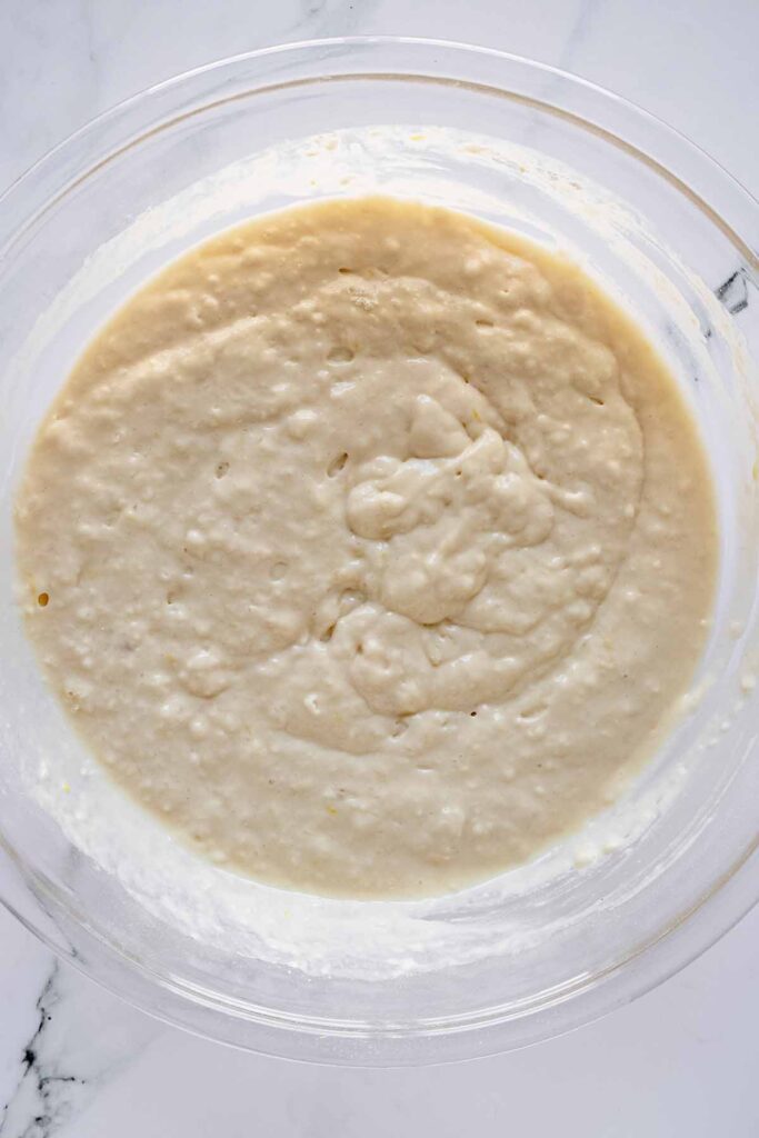 Overhead view of pancake batter in a glass bowl