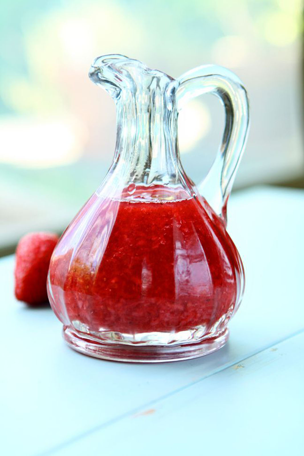 Strawberry compote in a glass carafe