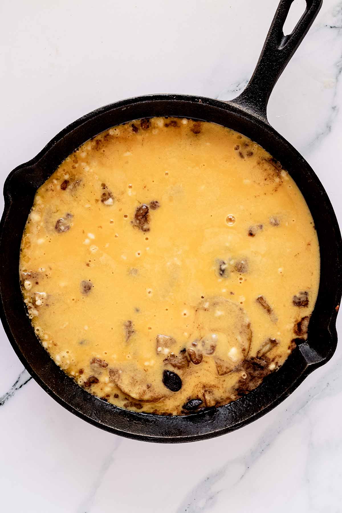 Overhead view of batter poured on top of apple mixture