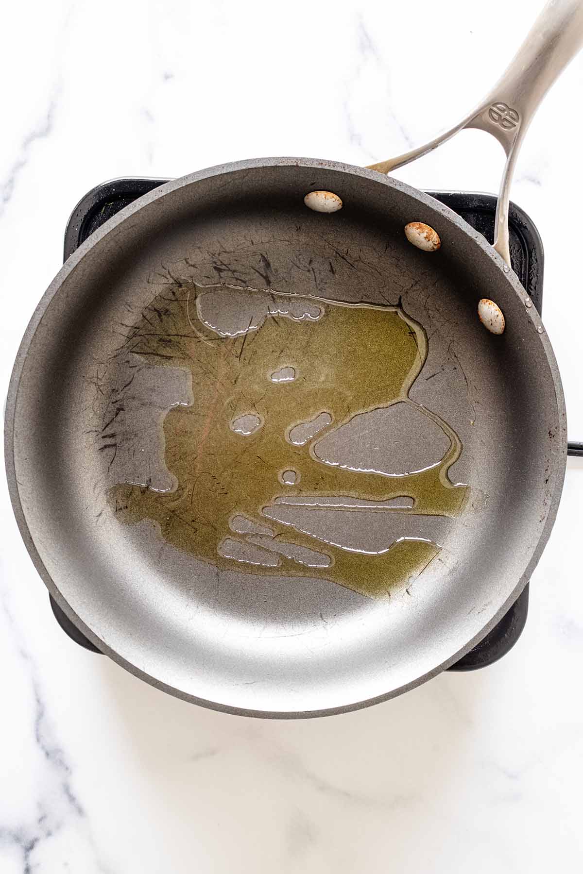 Overhead view of olive oil in a skillet