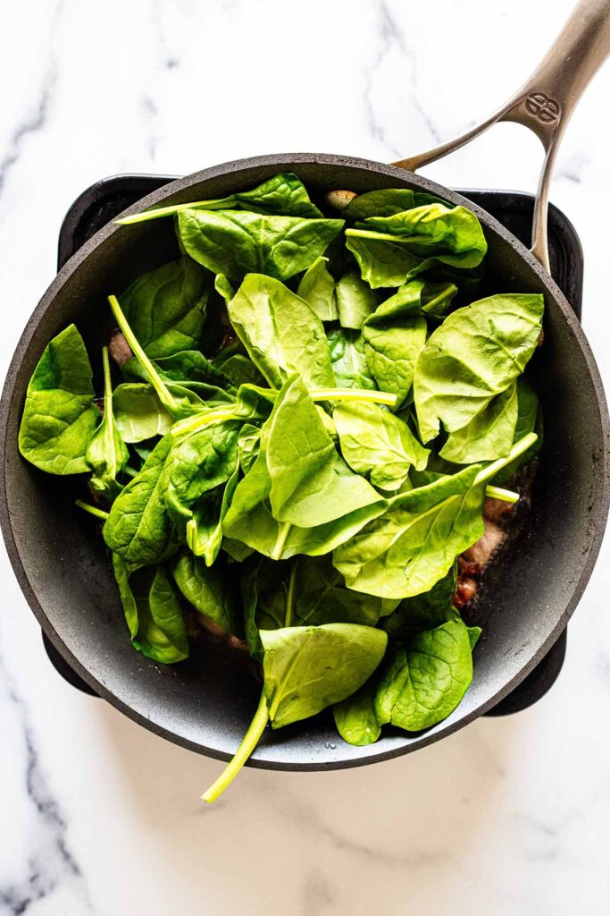 Spinach cooking in a skillet