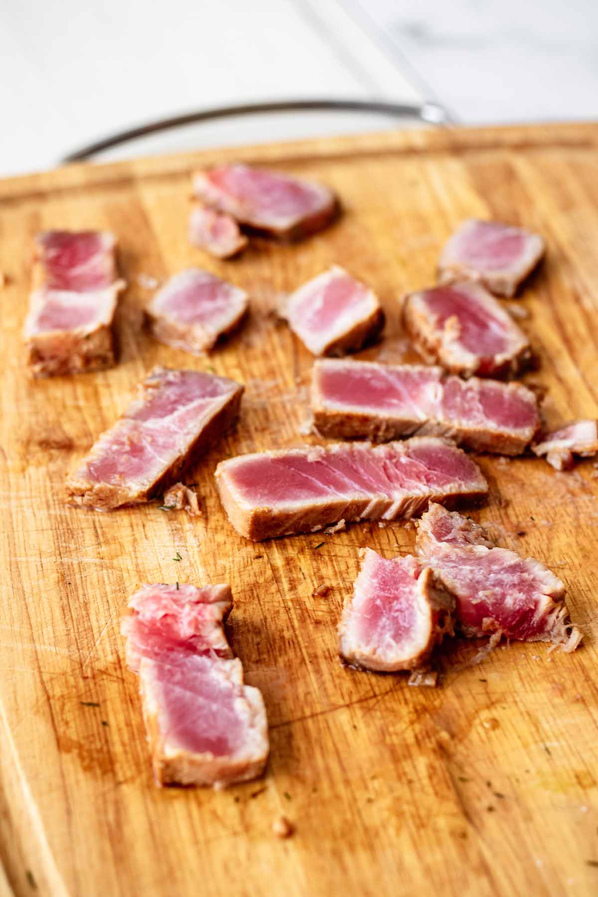 Seared ahi tuna slices on a cutting board
