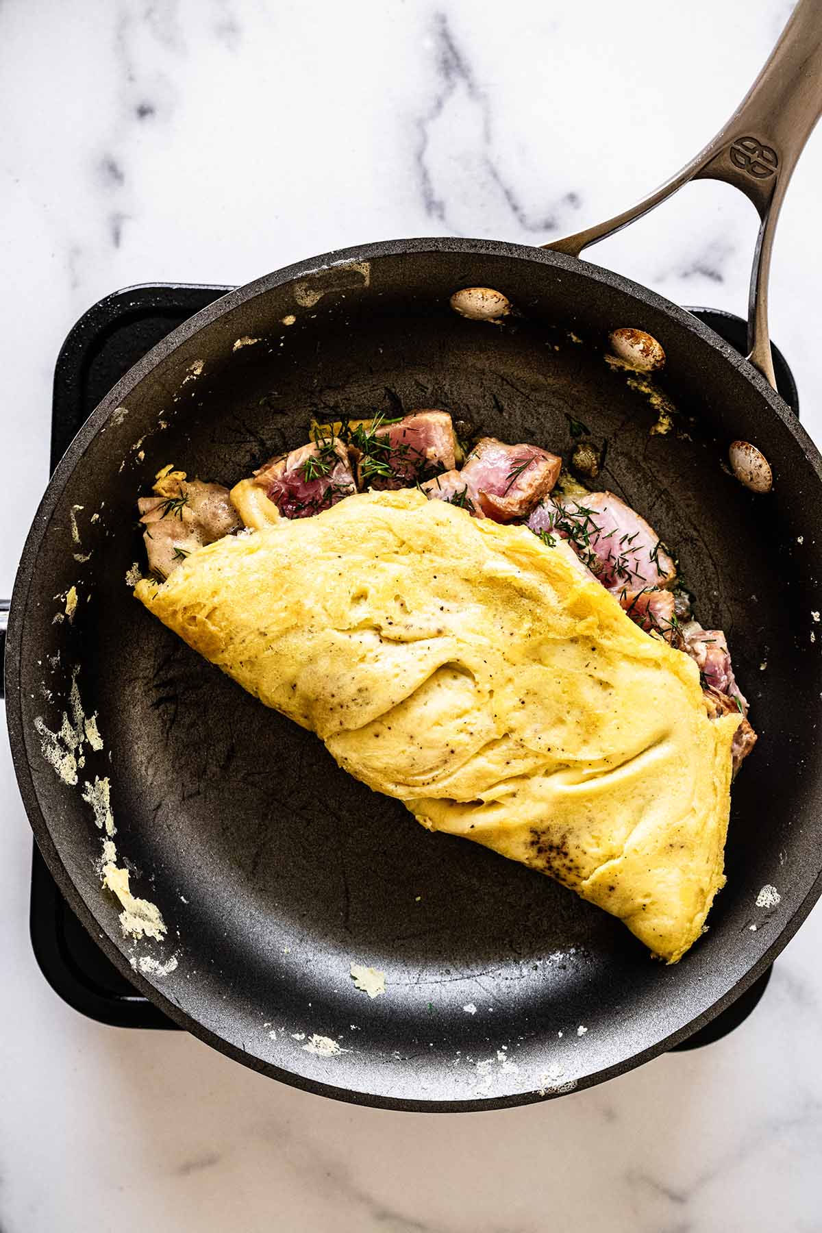 Overhead view of cooked omelette in a skillet