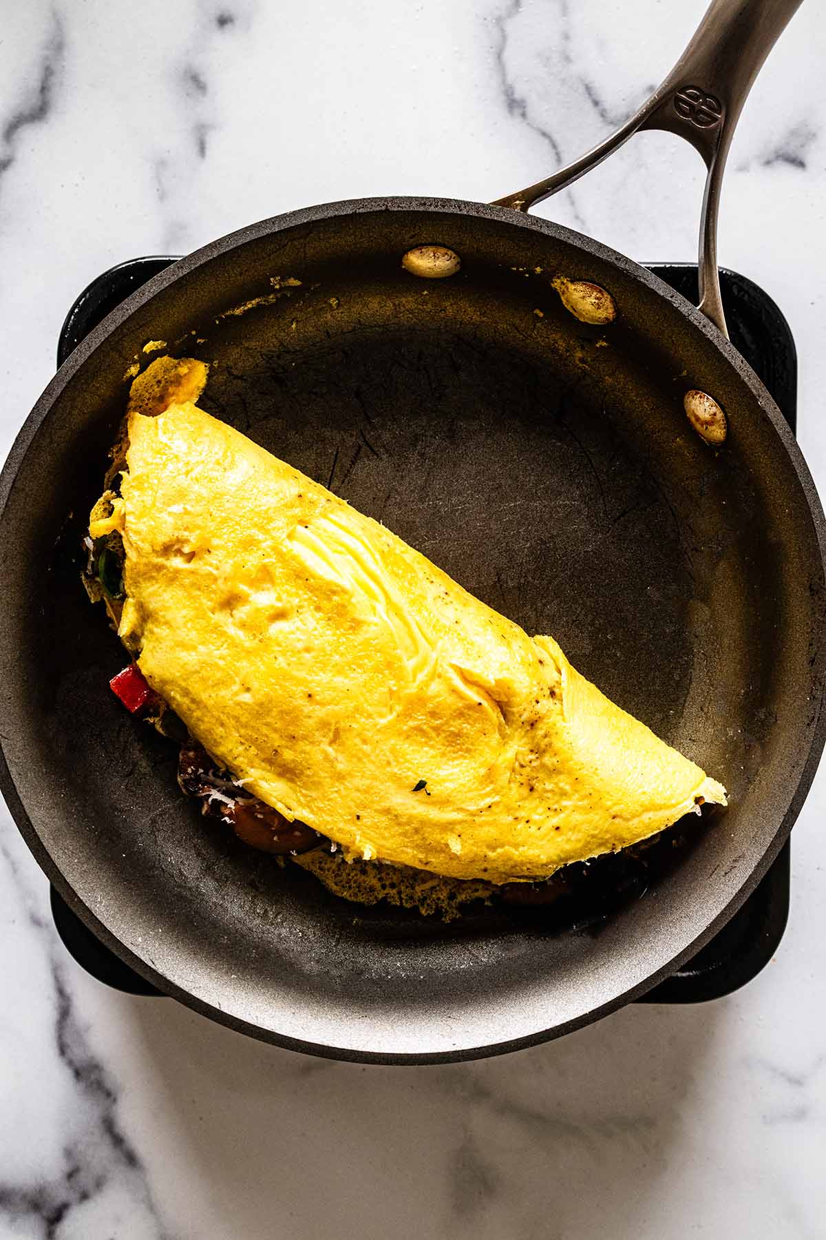 Folded omelette cooking in a skillet