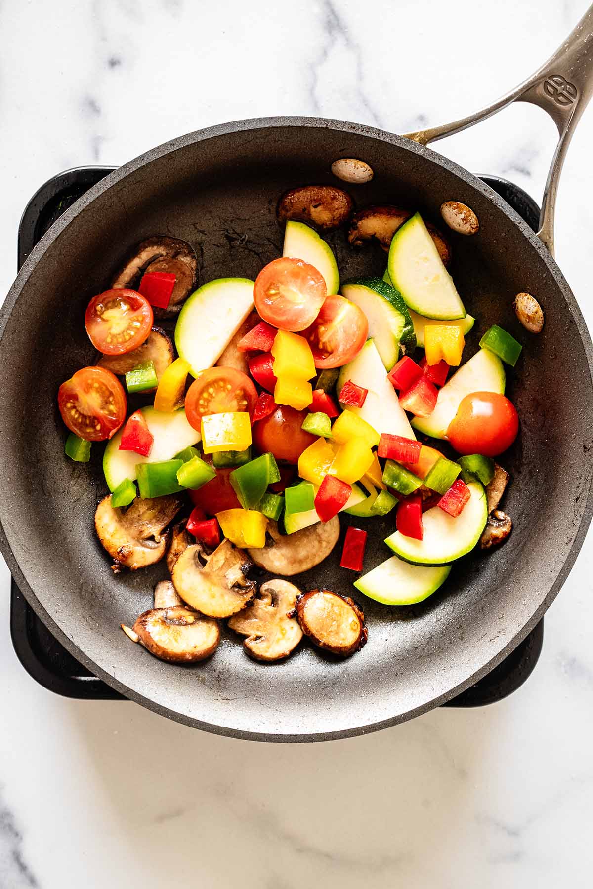 Chopped vegetables cooking in a skillet