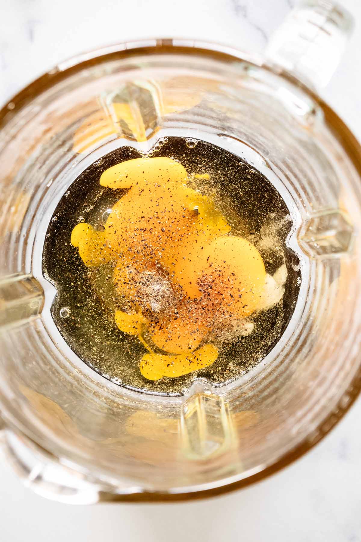 Overhead view of eggs, salt and pepper in a blender