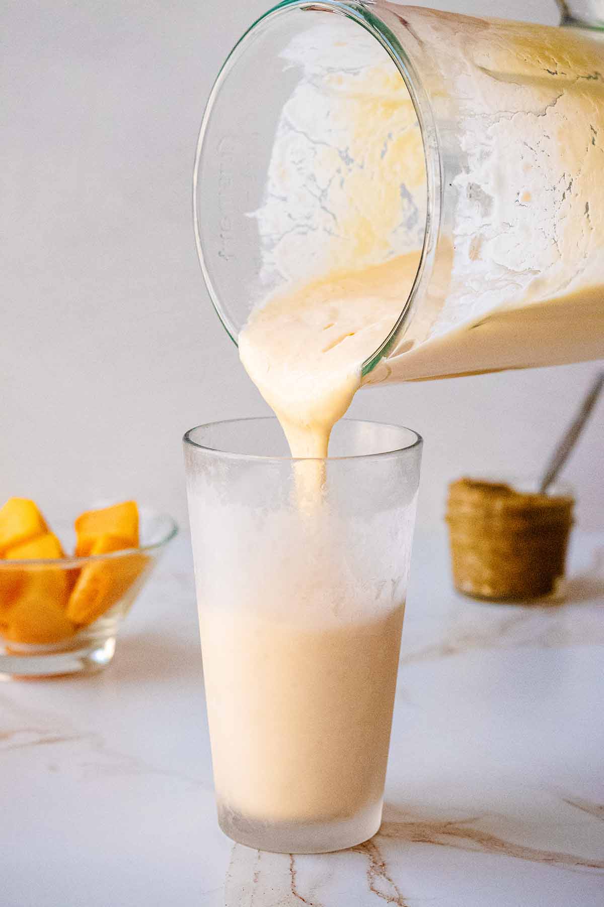 Smoothie being poured into a chilled glass