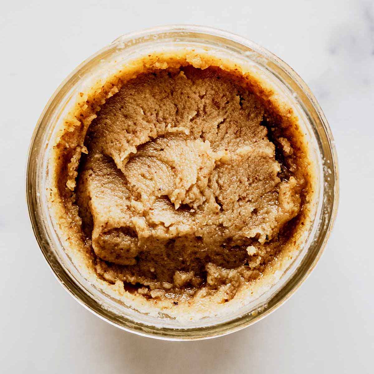 Overhead view of walnut butter in a jar