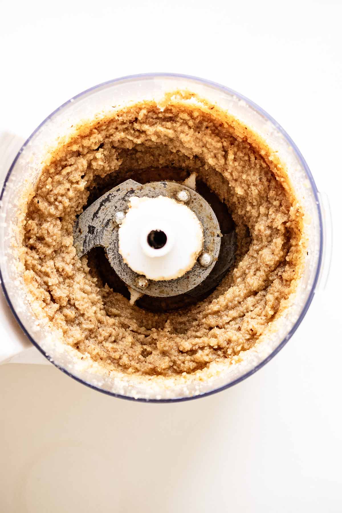 Overhead view of homemade nut butter in a food processor
