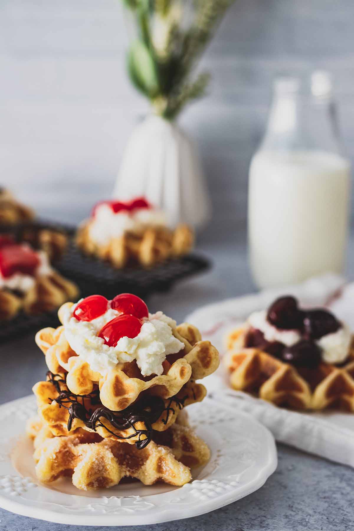 Stack of mini waffles on a white plate