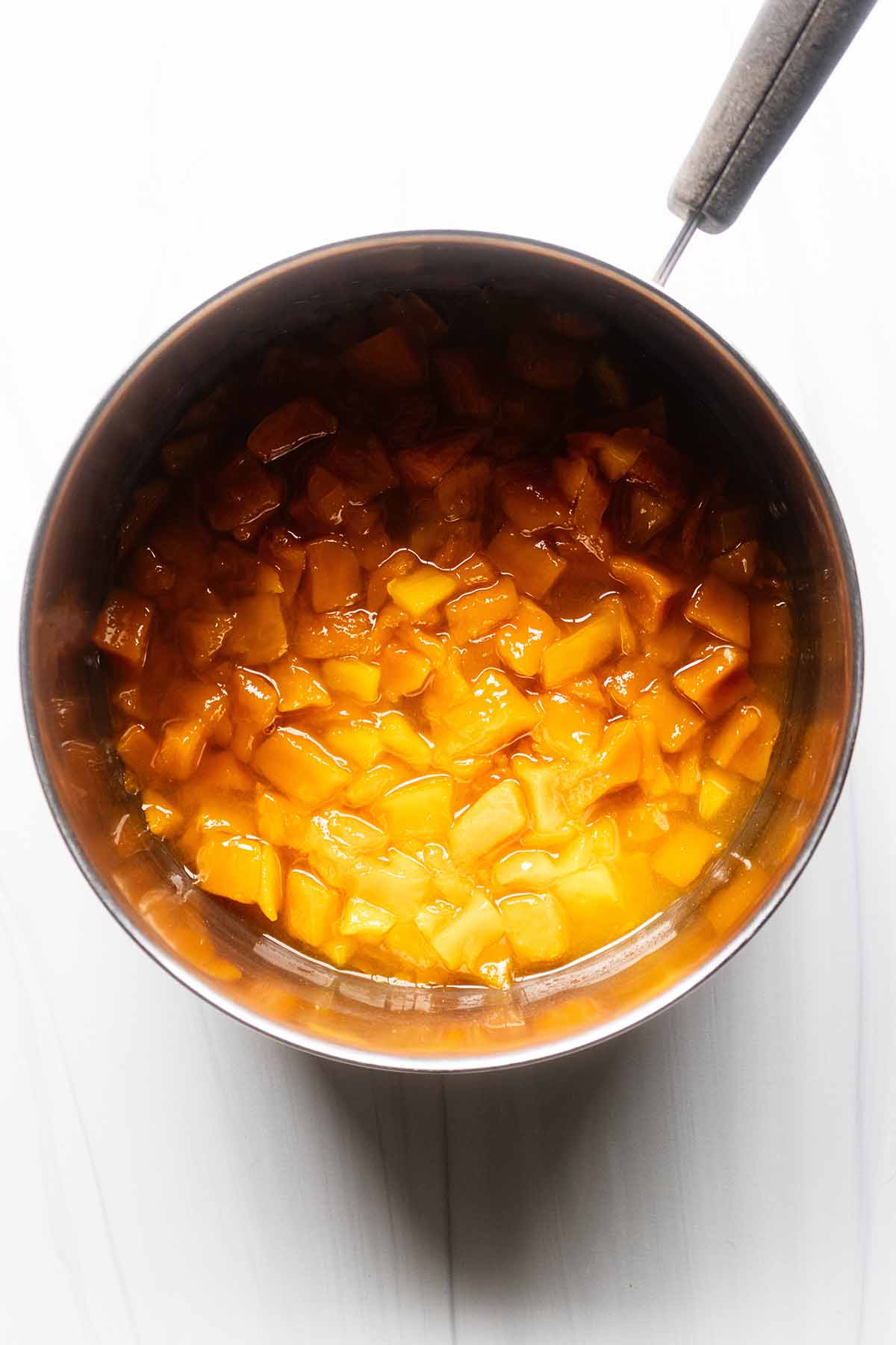 Overhead view finished mango compote in a saucepan