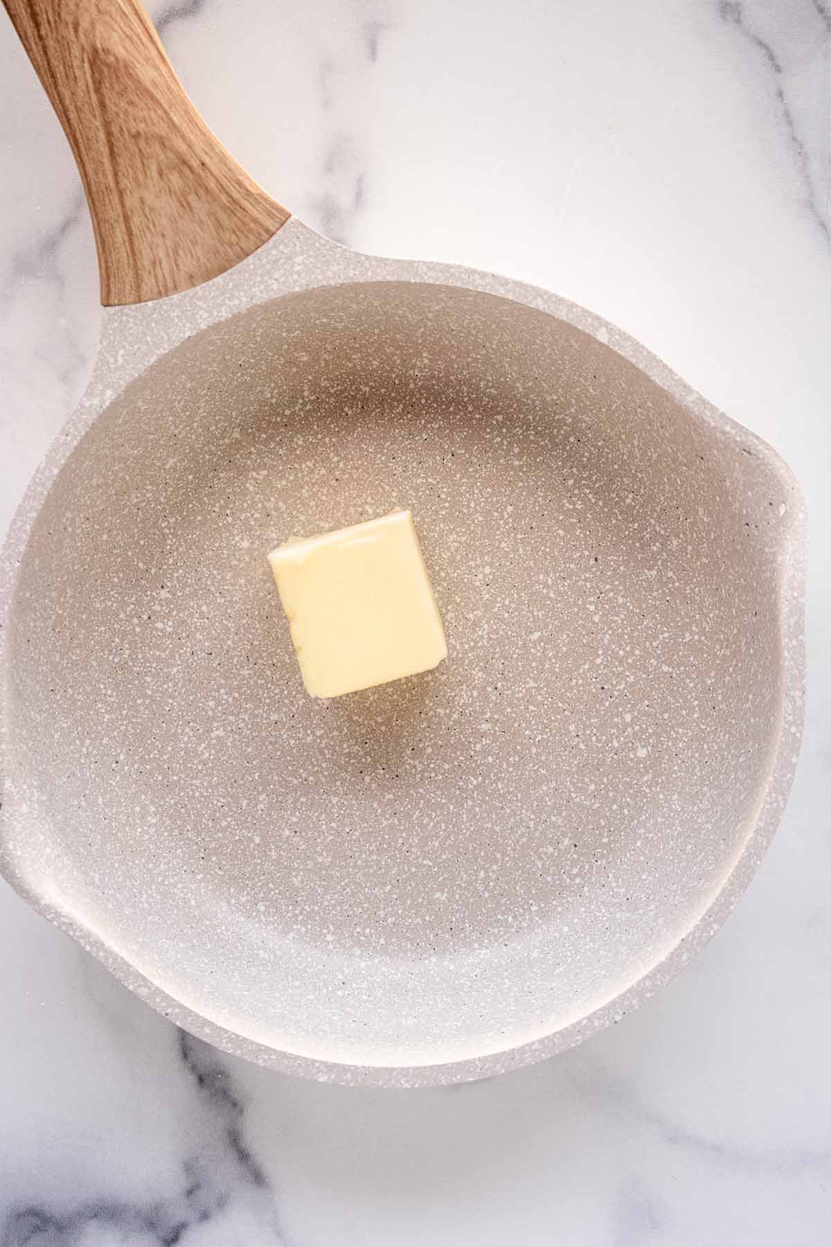 Overhead view of butter in a skillet