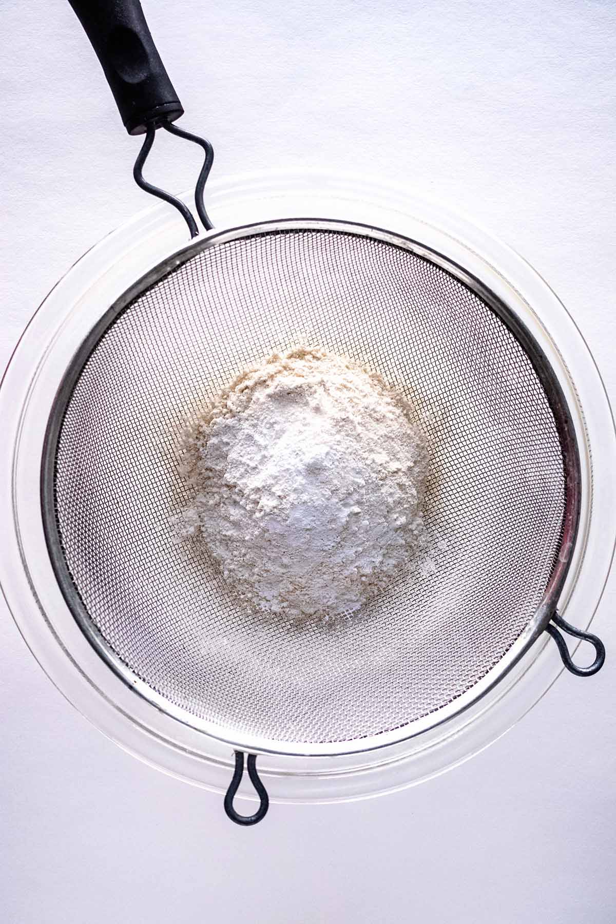 Top view of dry ingredients levered into a glass bowl