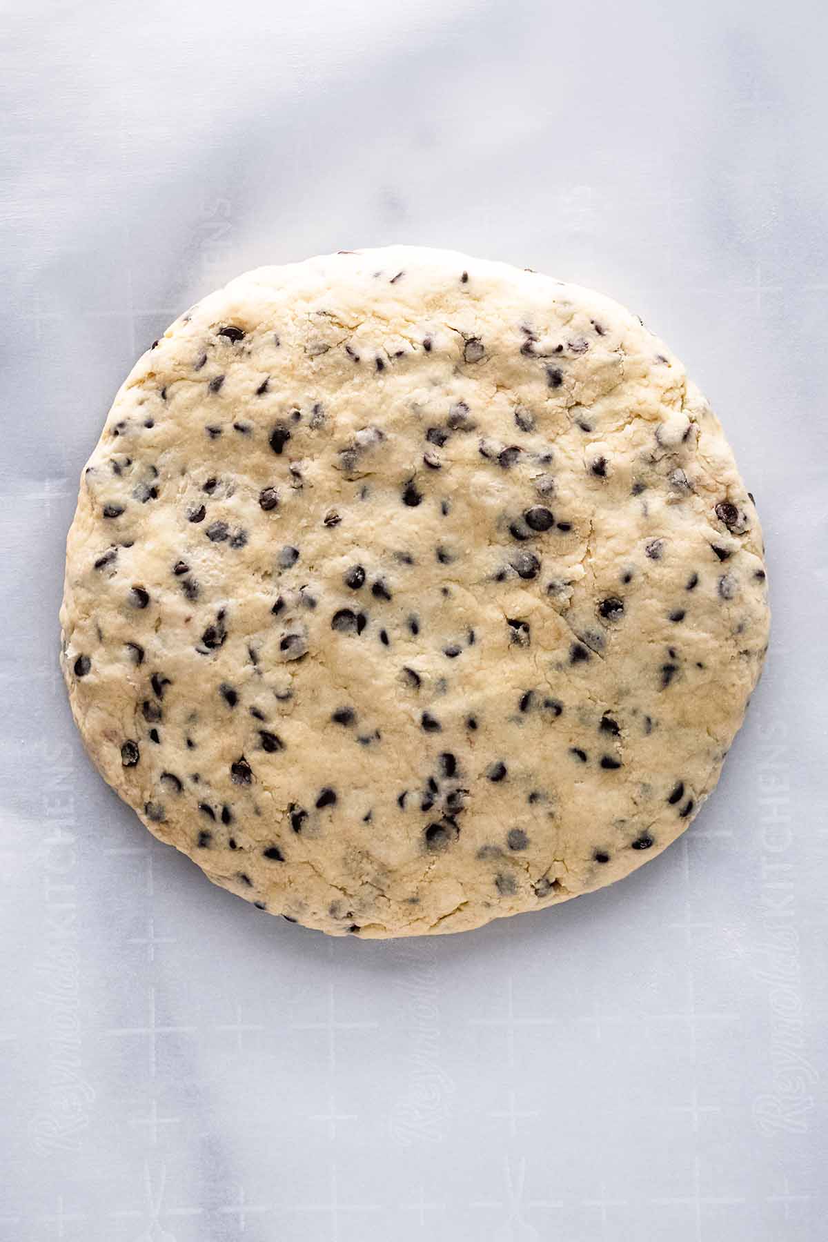 Overhead view of scone dough shaped into a disc