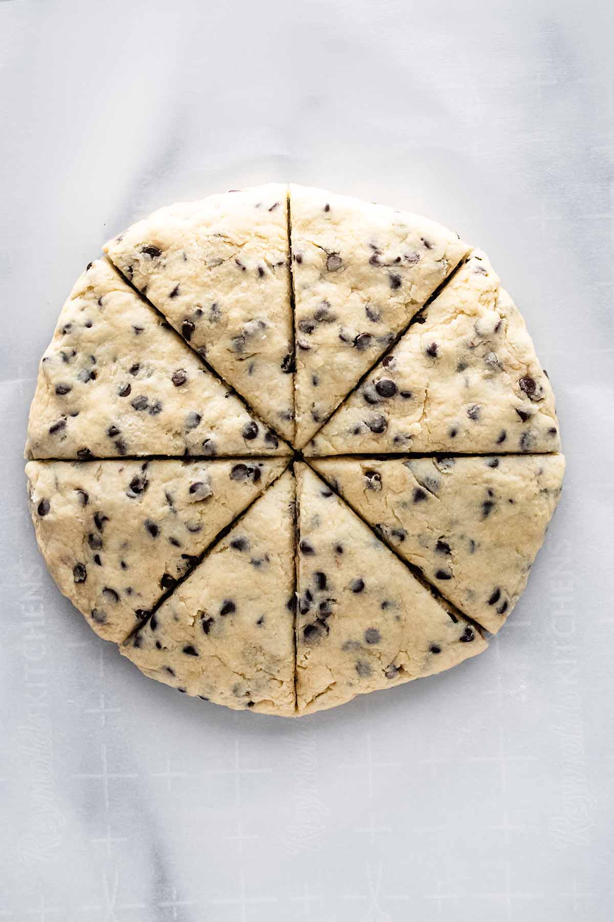 Overhead view of scone dough cut into 8 triangles