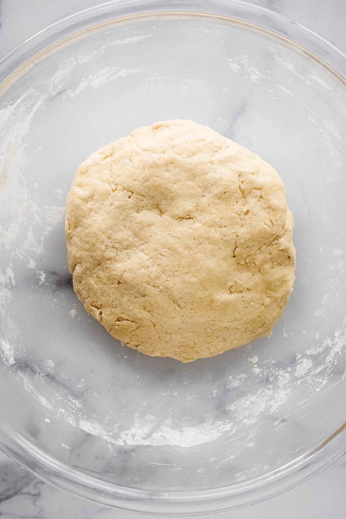 Overhead view of scone dough in a large glass bowl.