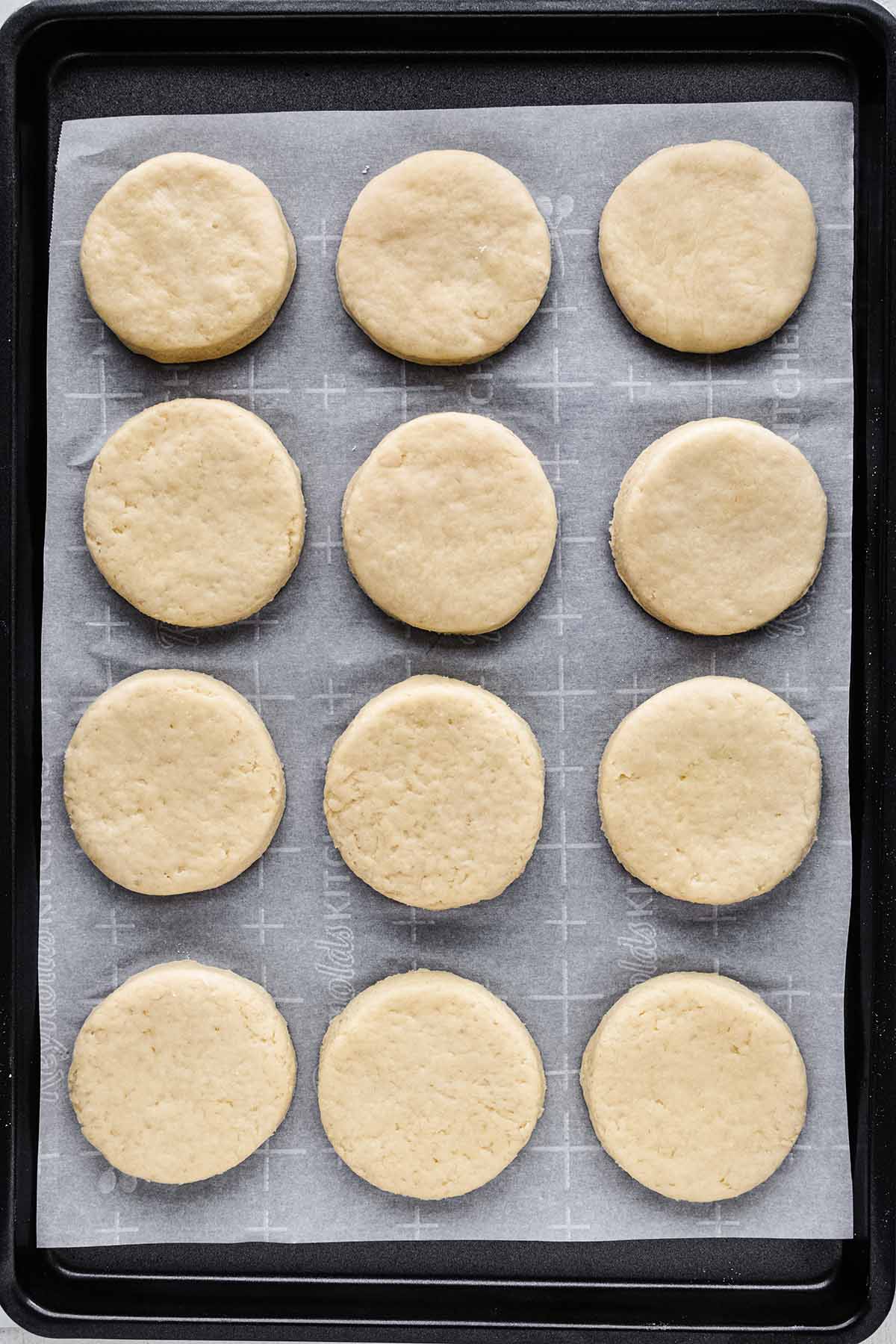 Overhead view of unbaked scones on a baking sheet.