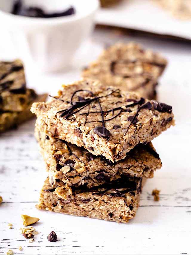 Stack of no bake oatmeal peanut butter bars on a white wood table