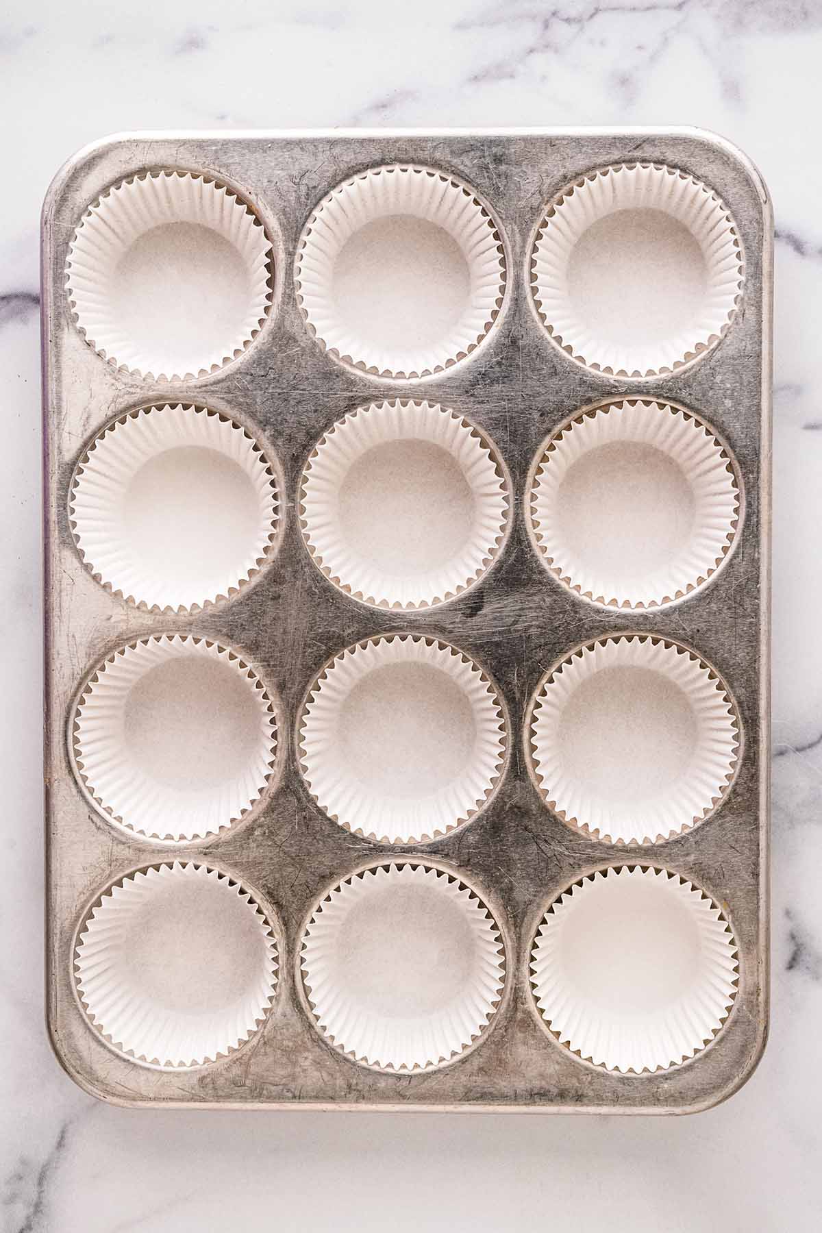 Muffin pan lined with paper liners.