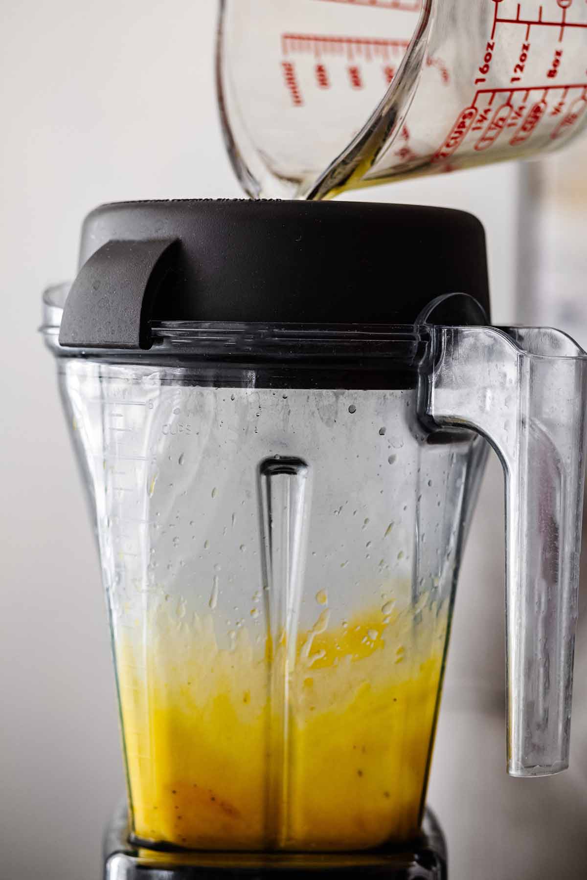 Warm melted butter being poured into a blender