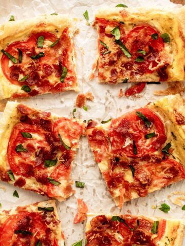 Puff pastry pizza slices on crumpled paper.