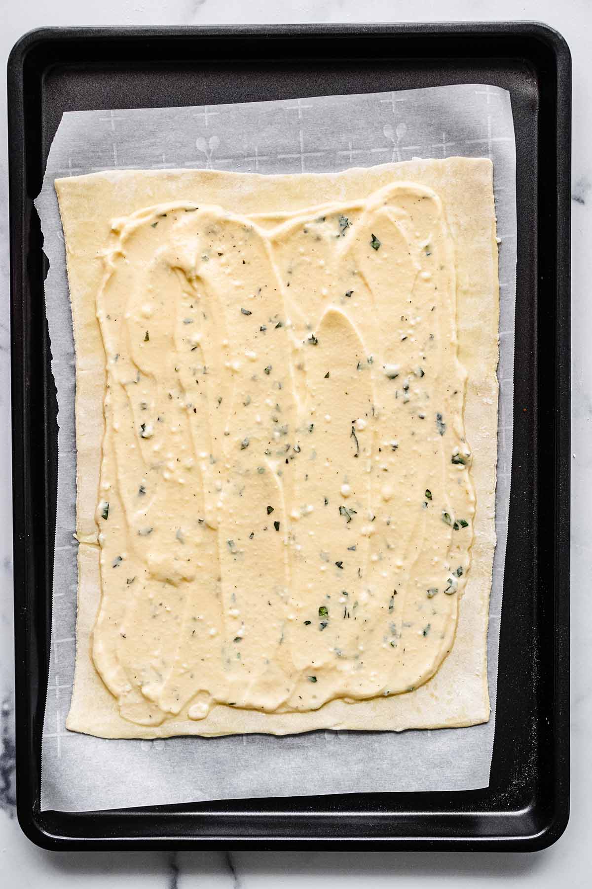 Ricotta mixture spread over the top of puff pastry sheet.