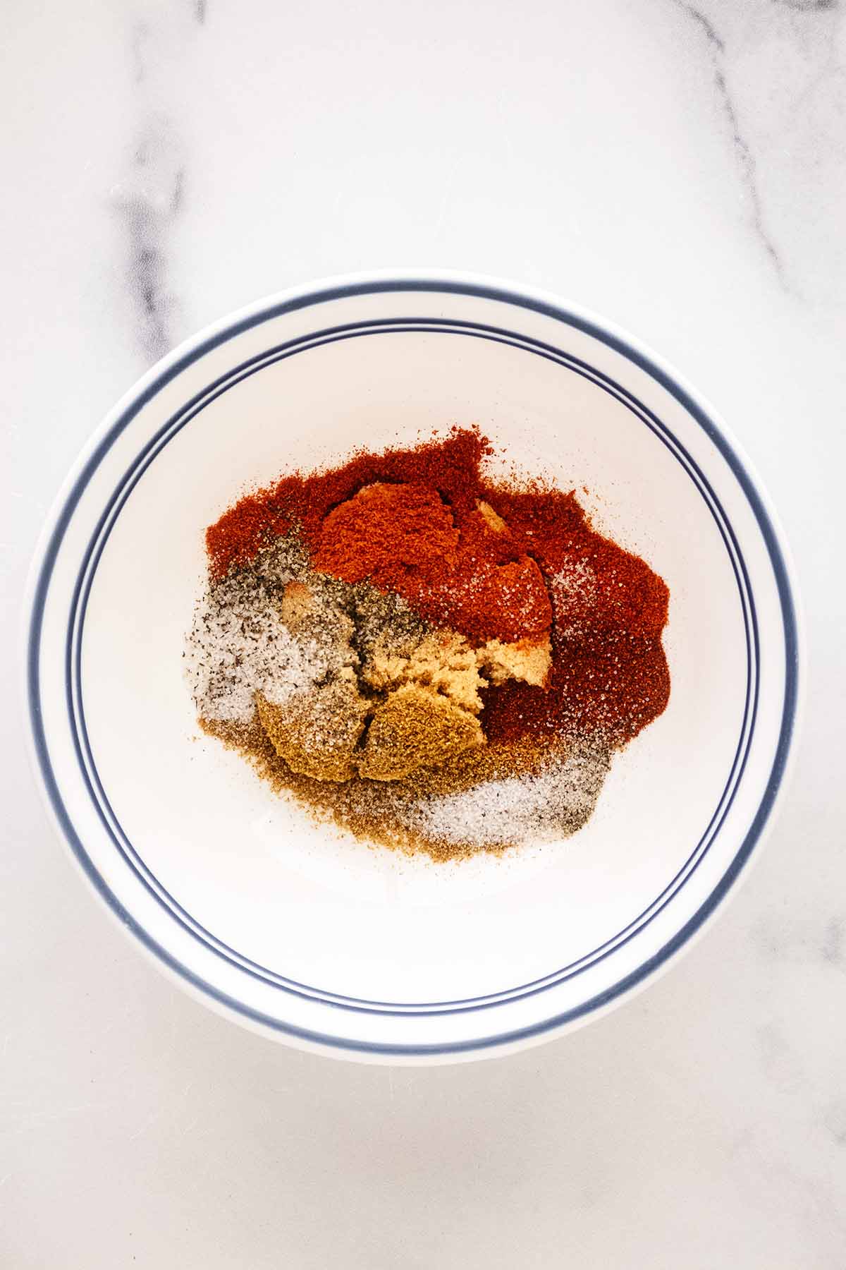Ingredients for spice rub in a small white bowl