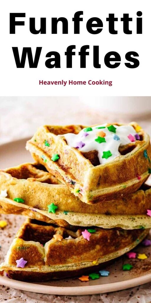Funfetti waffles stacked on a pink plate topped with whipped cream and candy sprinkles