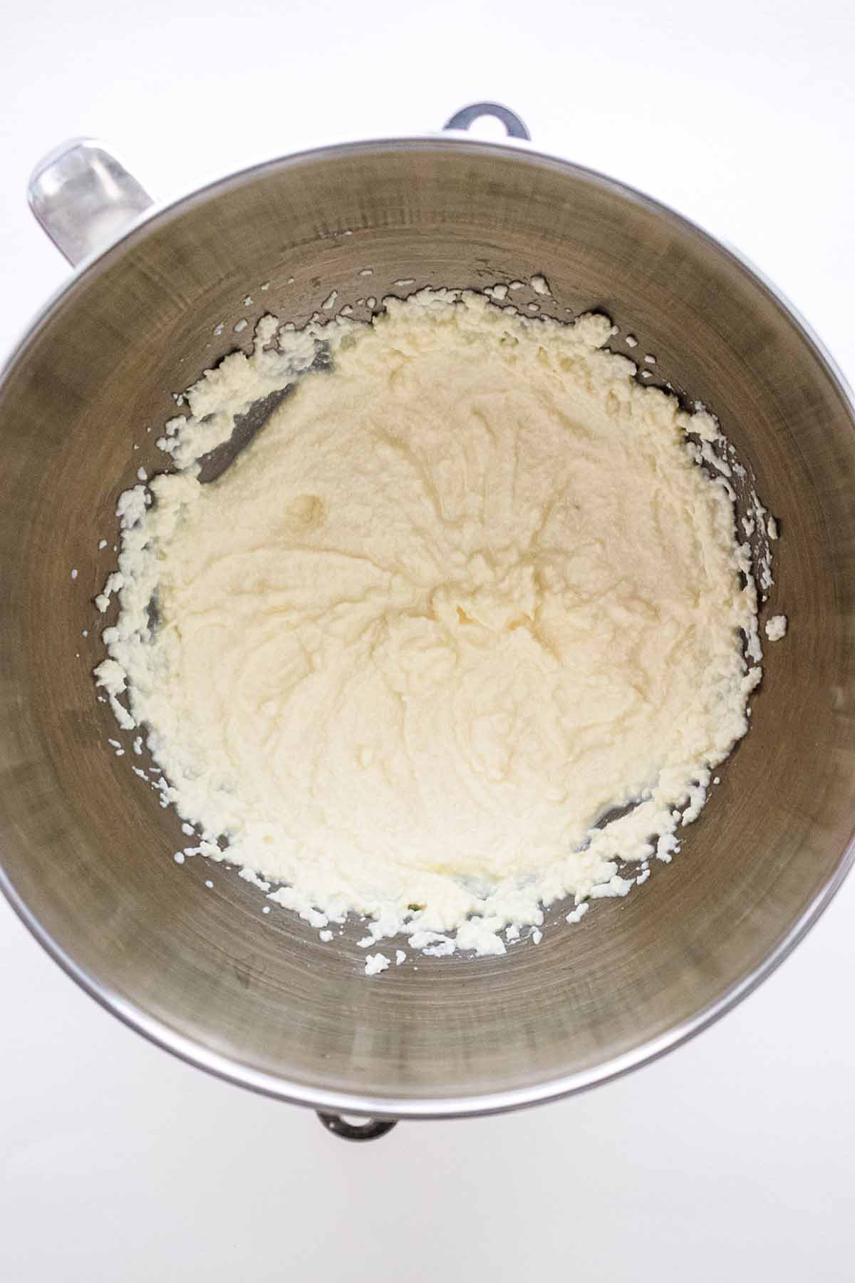 Whipped ricotta in a stainless steel bowl.