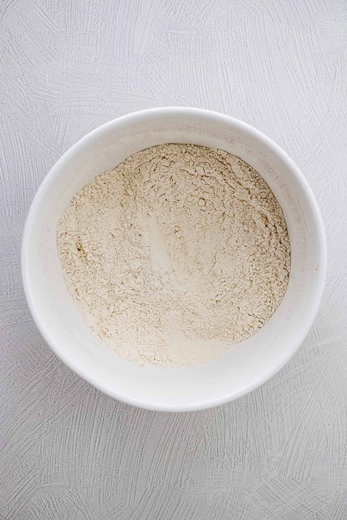 Dry ingredients in a white ceramic bowl.