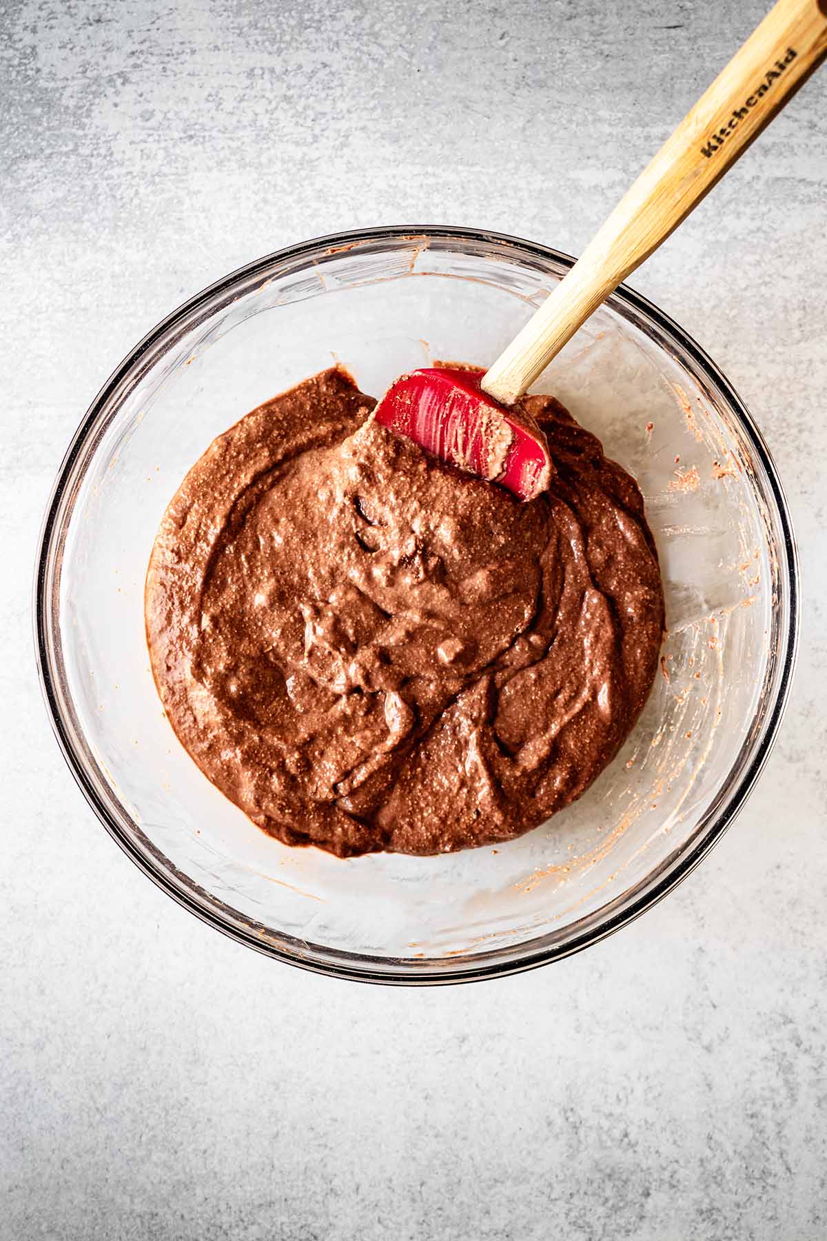 Chocolate protein pancake batter in a large glass bowl.