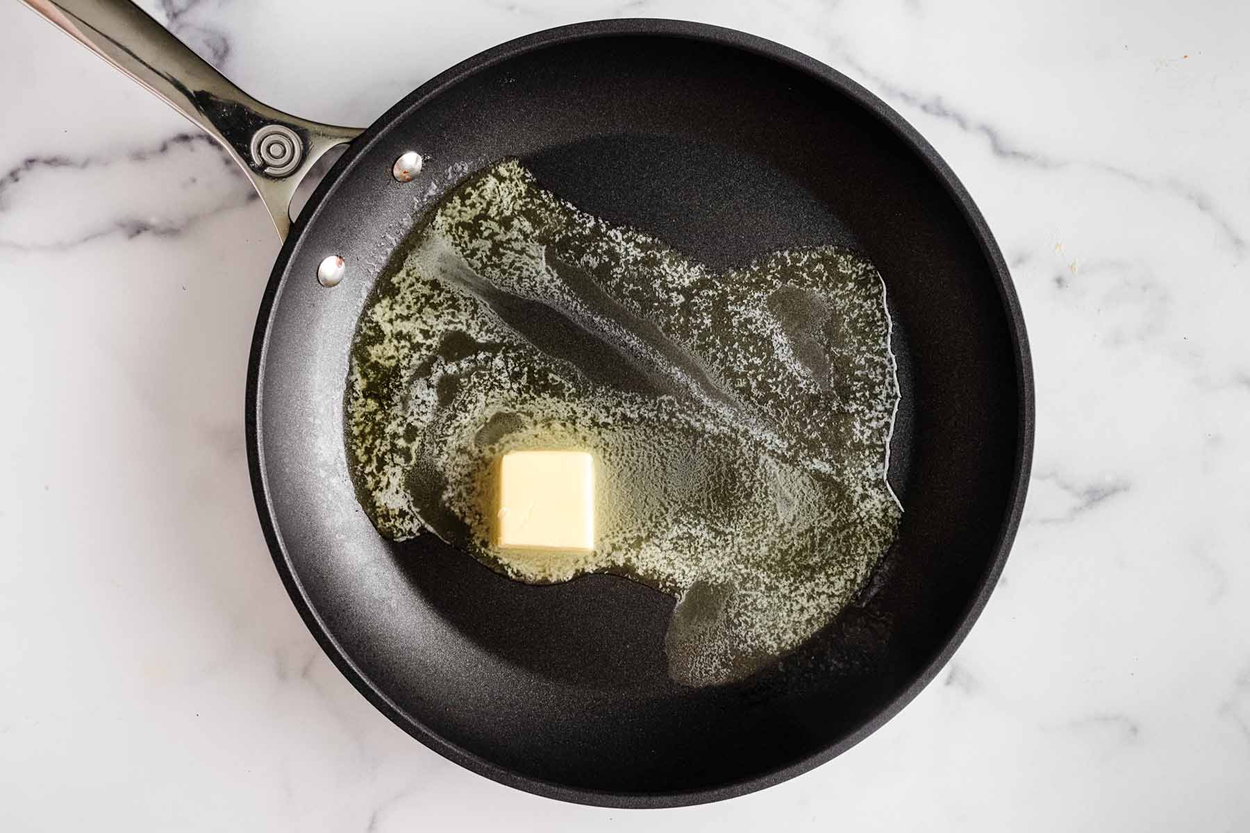 Butter melting in a skillet.