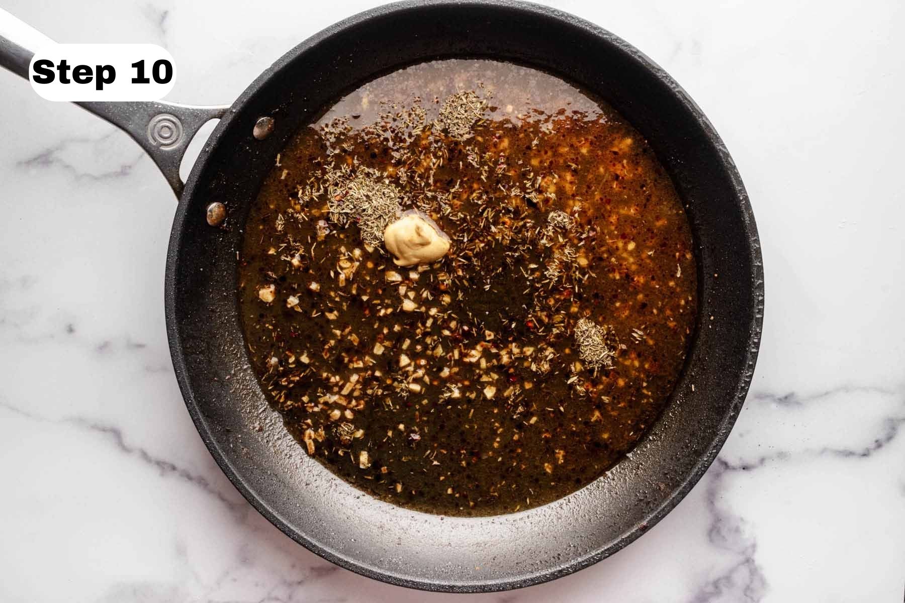 Dried thyme, Dijon mustard and honey added to a large skillet.