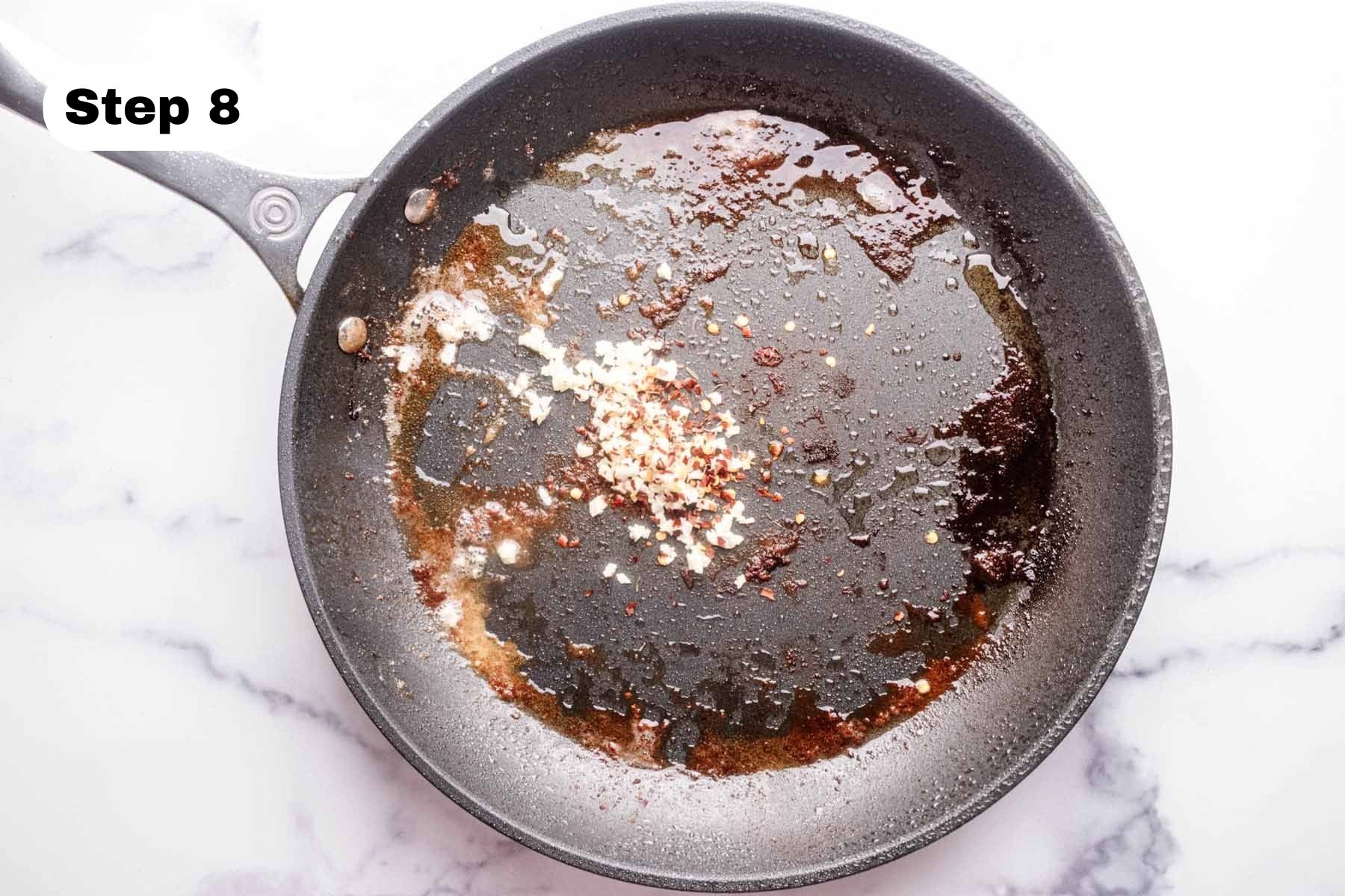 Minced garlic and red pepper flakes in a large skillet.
