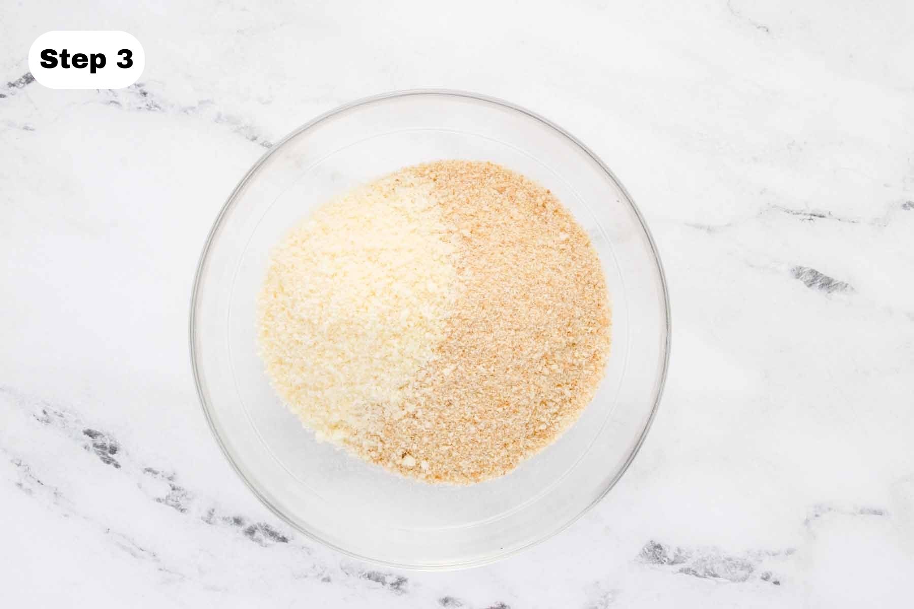 Parmesan and bread crumbs in a glass bowl.