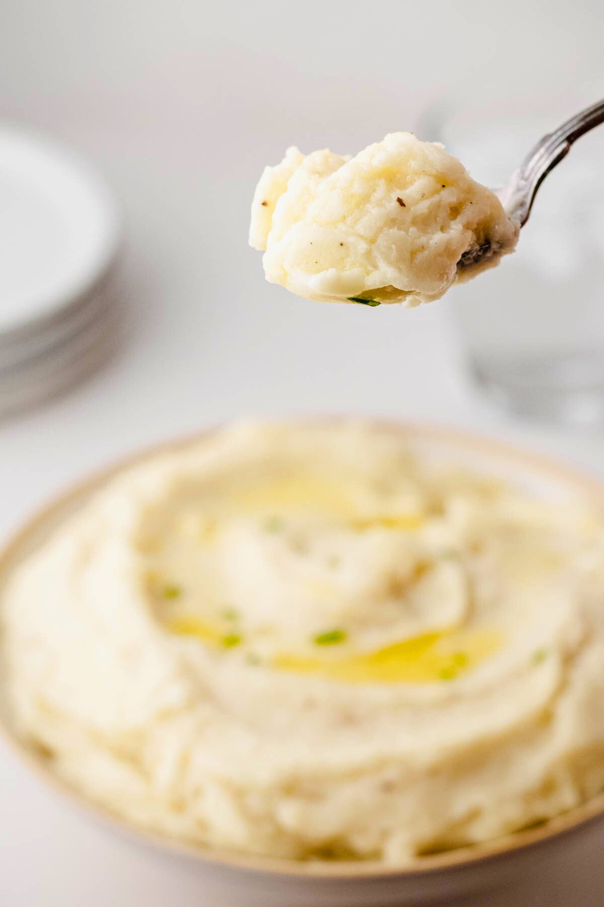 Close up of a spoonful of truffle mashed potatoes.