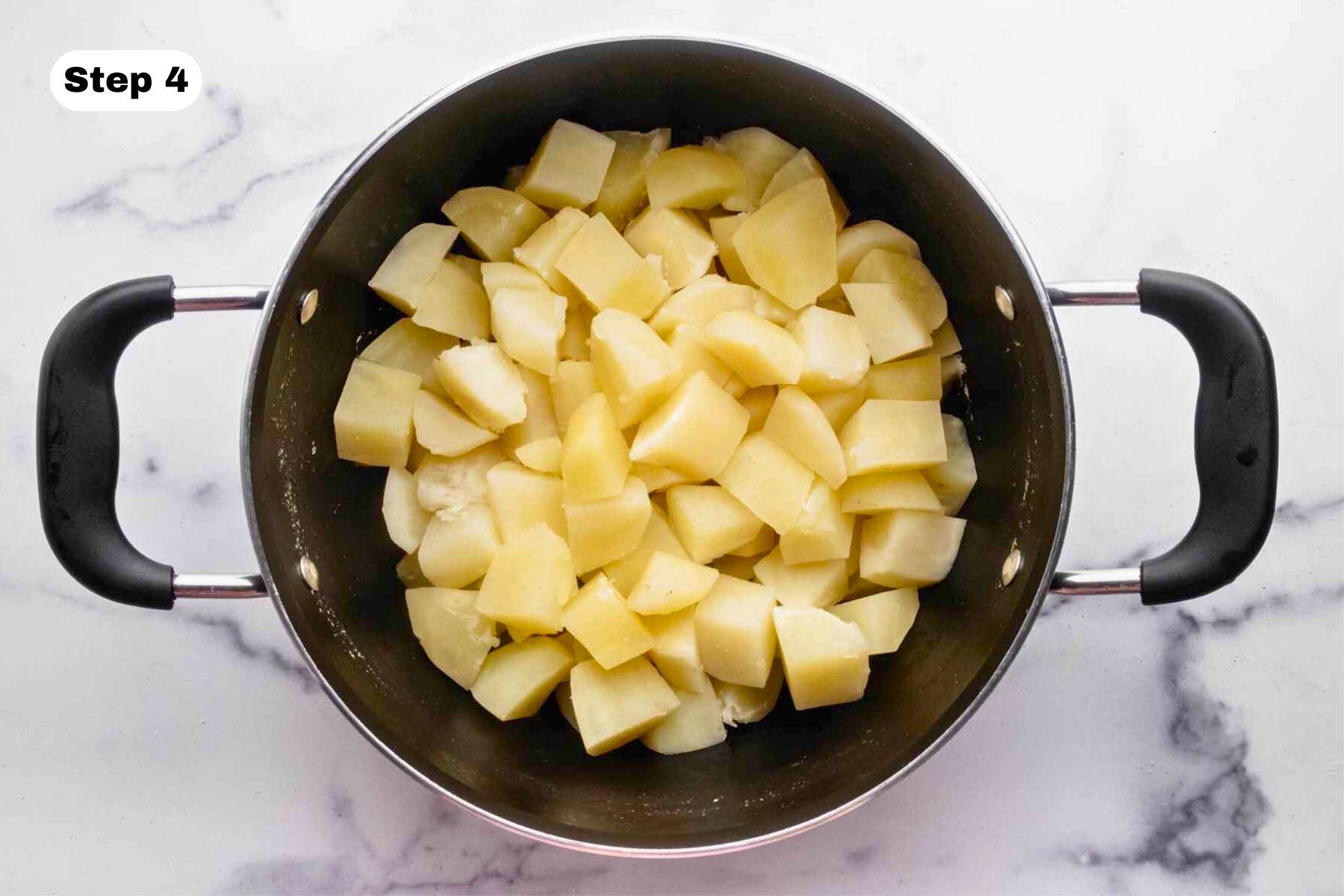 Cooked potatoes in a large pot.